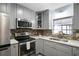 Kitchen featuring stainless steel appliances, a microwave, and a window above the sink at 1560 S Pearl St, Deland, FL 32720