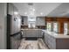 A kitchen featuring modern appliances, gray cabinetry, and an island with a white countertop at 1560 S Pearl St, Deland, FL 32720