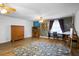 Bright living room with wood floors, ceiling fan, and dark accent wall at 1560 S Pearl St, Deland, FL 32720