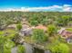 An aerial view showcasing the property with a screened pool, and water access at 1578 Stone Trl, Deltona, FL 32725