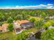 An aerial view of the home featuring a screened pool, dock and pond at 1578 Stone Trl, Deltona, FL 32725