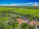 Beautiful aerial view of a single-Gathering home with a screened pool, lush landscaping, and amazing waterfront views at 1578 Stone Trl, Deltona, FL 32725