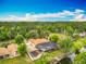 An aerial view of a beautiful home featuring a screened pool, pond and a dock at 1578 Stone Trl, Deltona, FL 32725
