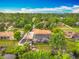 An aerial view displays a home with screened pool and private dock on a scenic waterway at 1578 Stone Trl, Deltona, FL 32725