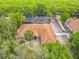 Stunning aerial view of a single-Gathering home with a screened pool, lush landscaping, and beautiful waterfront views at 1578 Stone Trl, Deltona, FL 32725