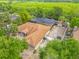 Stunning aerial view of a single-Gathering home with a screened pool, lush landscaping, and beautiful waterfront views at 1578 Stone Trl, Deltona, FL 32725