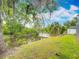 Landscaped backyard featuring a private dock on the canal, perfect for relaxing and enjoying nature at 1578 Stone Trl, Deltona, FL 32725