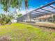 A backyard with a screened pool, offering a private outdoor oasis with views of the canal at 1578 Stone Trl, Deltona, FL 32725