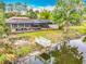 Backyard featuring a private dock, screened lanai, and waterfront views, perfect for outdoor relaxation at 1578 Stone Trl, Deltona, FL 32725