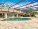 Inviting backyard pool area with lounging and dining spaces, screened enclosure, and lush landscaping at 1578 Stone Trl, Deltona, FL 32725