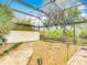 Spacious backyard with a screened enclosure, lush landscaping, brick pavers and peaceful outdoor living space at 1578 Stone Trl, Deltona, FL 32725