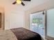 Bright bedroom with ceiling fan, closet, and view of the screened-in pool at 1578 Stone Trl, Deltona, FL 32725