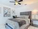 This bright bedroom boasts a ceiling fan, tiled floors, and modern decor at 1578 Stone Trl, Deltona, FL 32725