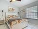 Bright bedroom featuring a ceiling fan, stylish bedding, and ample natural light from a large window at 1578 Stone Trl, Deltona, FL 32725
