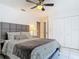 This bright bedroom boasts a ceiling fan, tiled floors, and ample closet space at 1578 Stone Trl, Deltona, FL 32725