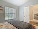 Bright bedroom with patterned bedding, large window, and doorway to another room at 1578 Stone Trl, Deltona, FL 32725