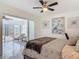 Bright bedroom with ceiling fan, patio access, neutral walls and heron wall art at 1578 Stone Trl, Deltona, FL 32725