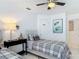 Bright bedroom features white walls, tiled floors, a ceiling fan, and two twin beds at 1578 Stone Trl, Deltona, FL 32725