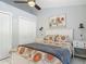 Comfortable bedroom with white furnishings, ceiling fan, and patterned bedding at 1578 Stone Trl, Deltona, FL 32725