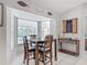 Cozy breakfast nook with views of the pool area through large windows, wooden table, and nautical themed wall decor at 1578 Stone Trl, Deltona, FL 32725
