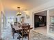 Dining room featuring a wooden table with seating, stylish lighting, and an open view to the living area at 1578 Stone Trl, Deltona, FL 32725