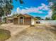 Beautiful brick house featuring a two-car garage, circular driveway, manicured lawn, and lush tropical landscaping at 1578 Stone Trl, Deltona, FL 32725