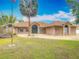 Charming one-story brick home with a well-manicured lawn, beautiful arched windows, and circular driveway at 1578 Stone Trl, Deltona, FL 32725
