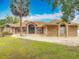 Charming one-story brick home with a well-manicured lawn, beautiful arched windows, and circular driveway at 1578 Stone Trl, Deltona, FL 32725