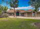 Charming one-story brick home with a well-manicured lawn, beautiful arched windows, and circular driveway at 1578 Stone Trl, Deltona, FL 32725