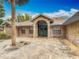 Charming brick home featuring a lush front yard, decorative iron entry, and a beautiful brick-paved driveway at 1578 Stone Trl, Deltona, FL 32725