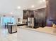 Modern kitchen with stainless steel appliances, granite countertops, and ample cabinet space at 1578 Stone Trl, Deltona, FL 32725