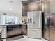 Modern kitchen showcases dark cabinetry, stainless steel refrigerator, and access to a cozy breakfast nook at 1578 Stone Trl, Deltona, FL 32725