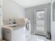 Laundry room featuring tile flooring and modern washer and dryer units at 1578 Stone Trl, Deltona, FL 32725