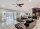 Inviting living room showcases tile flooring, comfortable seating, and seamless transition to the outdoor pool area at 1578 Stone Trl, Deltona, FL 32725