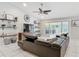 Spacious living room with tile floors, stylish decor, sliding doors to lanai and a comfortable sectional couch at 1578 Stone Trl, Deltona, FL 32725