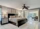 Bright main bedroom with a ceiling fan, a comfortable bed, and access to an outdoor dining area through sliding doors at 1578 Stone Trl, Deltona, FL 32725