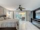 Spacious main bedroom with outdoor access, ceiling fan, and custom entertainment center with a fireplace at 1578 Stone Trl, Deltona, FL 32725