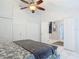 Comfortable main bedroom features white-tile floors, ceiling fan, and entry to ensuite bathroom at 1578 Stone Trl, Deltona, FL 32725