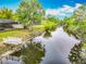 Tranquil canal featuring a private dock and a screened in porch in the background, perfect for enjoying outdoors at 1578 Stone Trl, Deltona, FL 32725