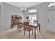 Cozy dining room with wood table and chairs, decorative buffet, and arched window, creating a warm atmosphere at 1933 Oak Estates Dr, Orange City, FL 32763