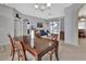 Formal dining area featuring a dark wood table and views of the living room and private pool area at 1933 Oak Estates Dr, Orange City, FL 32763
