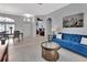 Open-concept living room with tile floors, an arched doorway, and a comfortable blue sofa at 1933 Oak Estates Dr, Orange City, FL 32763