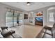 Relaxing living room with a sliding glass door to the pool area and tiled floors at 1933 Oak Estates Dr, Orange City, FL 32763