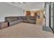 Bright open-plan living room featuring tile floors and an oversized leather sectional sofa at 1933 Oak Estates Dr, Orange City, FL 32763