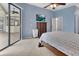 Bright main bedroom with tile floors, an outdoor view, and access to the bathroom at 1933 Oak Estates Dr, Orange City, FL 32763
