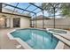 The screened-in pool with a spa is ready for relaxing and fun in the sun at 1933 Oak Estates Dr, Orange City, FL 32763