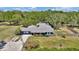 Aerial view of home showcasing expansive lot, driveway, and mature trees at 1941 Jungle Rd, New Smyrna Beach, FL 32168