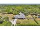 Lush aerial view of the property showcasing a home with mature trees, a large yard, and a private driveway at 1941 Jungle Rd, New Smyrna Beach, FL 32168