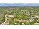 Overhead view of the home nestled within wooded acreage and a neighboring equestrian training area at 1941 Jungle Rd, New Smyrna Beach, FL 32168