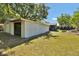 Large grassy backyard with the main house and garage at 1941 Jungle Rd, New Smyrna Beach, FL 32168